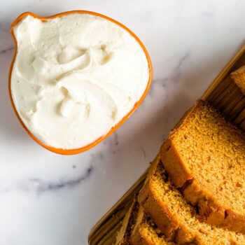 sliced pumpkin bread and cream cheese frosting