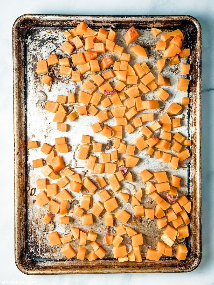 roasted butternut squash and shallots on metal sheet pan