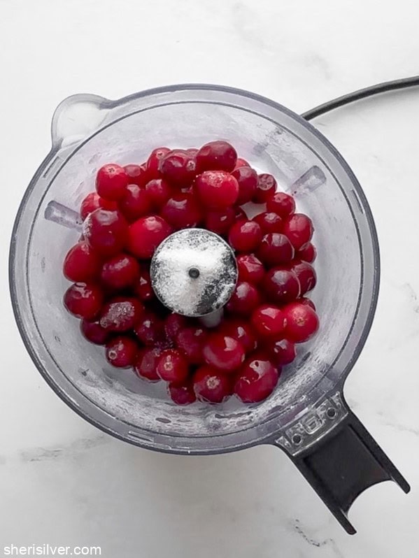 Fresh cranberries combined with vanilla sugar before pulsing.