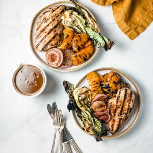 grilled chicken and vegetables on white ceramic plates