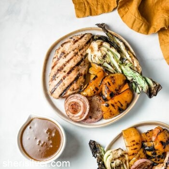 grilled chicken and vegetables on white ceramic plates