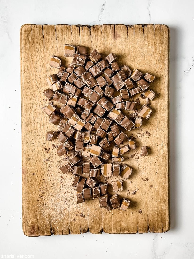 sliced milky way bars on a wooden board