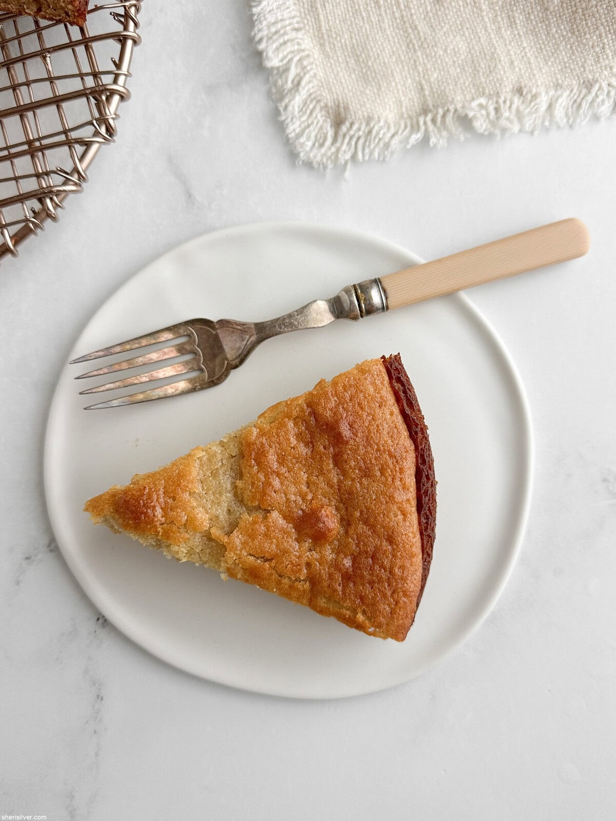 Close-up of moist, tender honey lemon yogurt cake slice showing soft crumb and golden crust.
