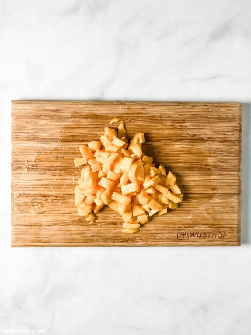 diced mango on a wooden cutting board