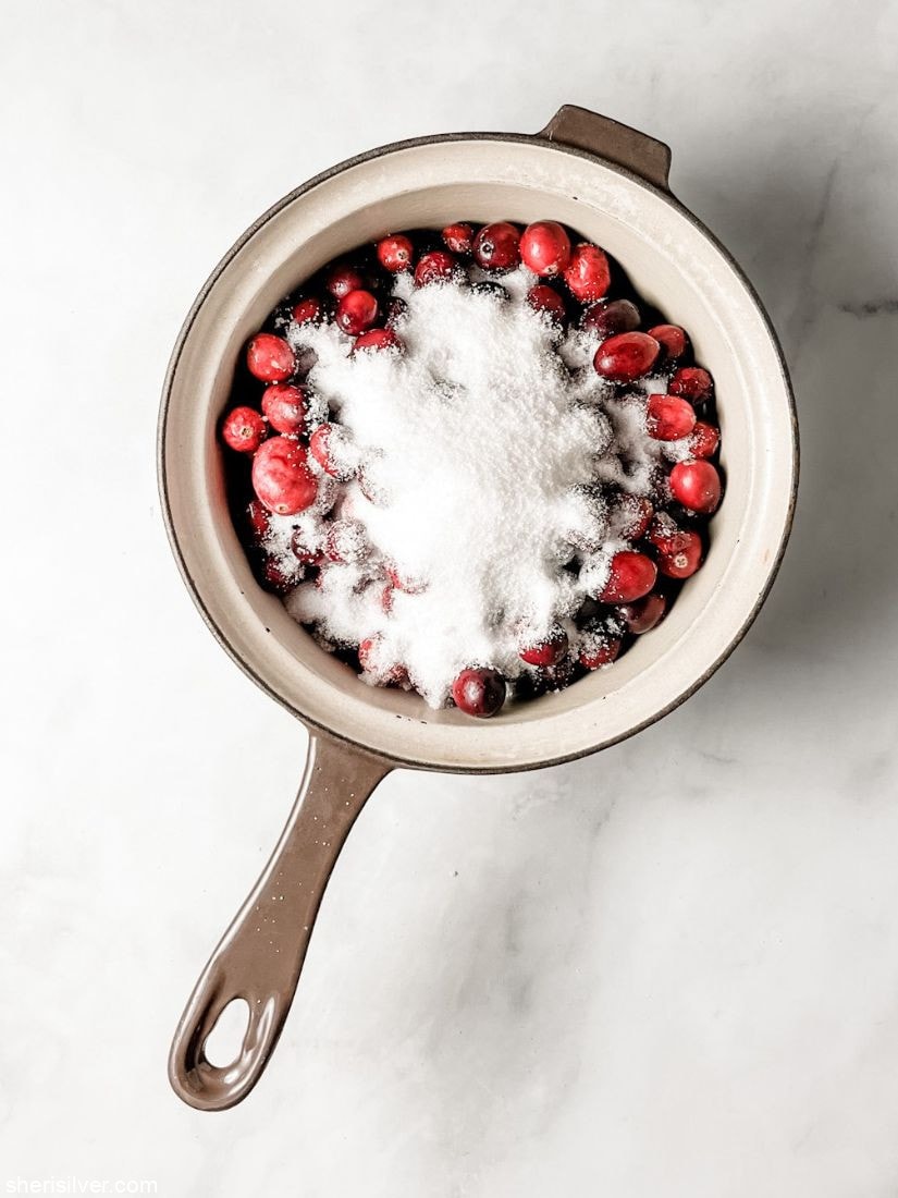 cranberries and sugar in a vintage saucepan