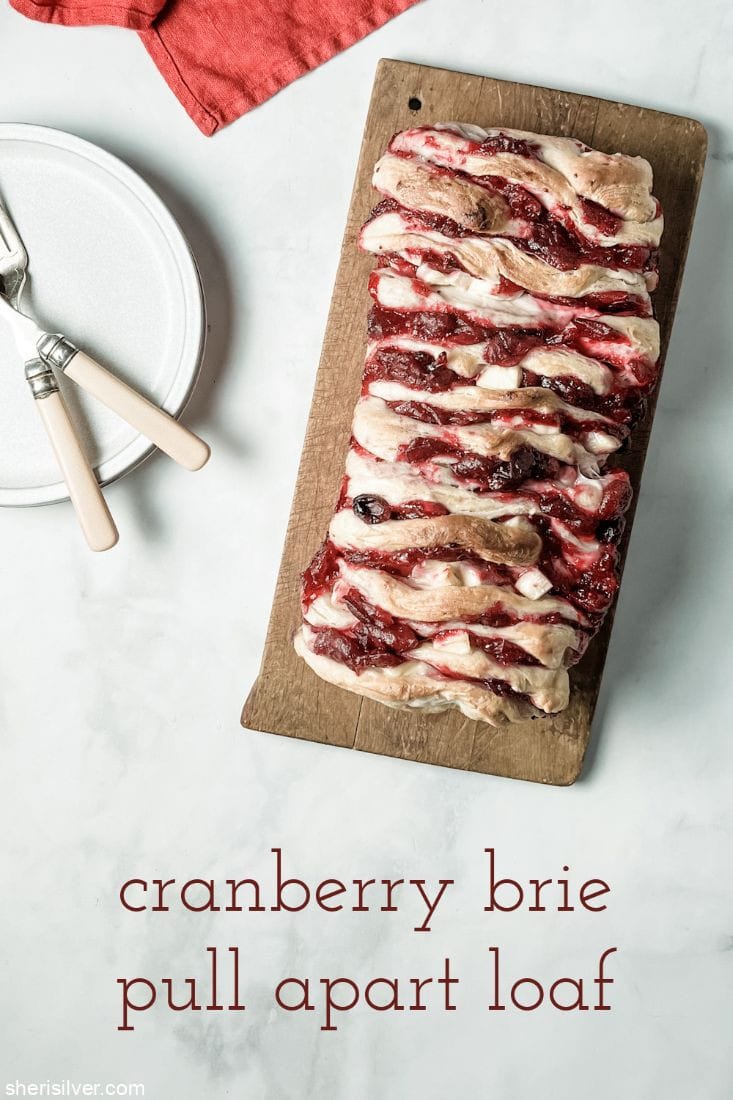 cranberry brie pull apart loaf on a wooden board