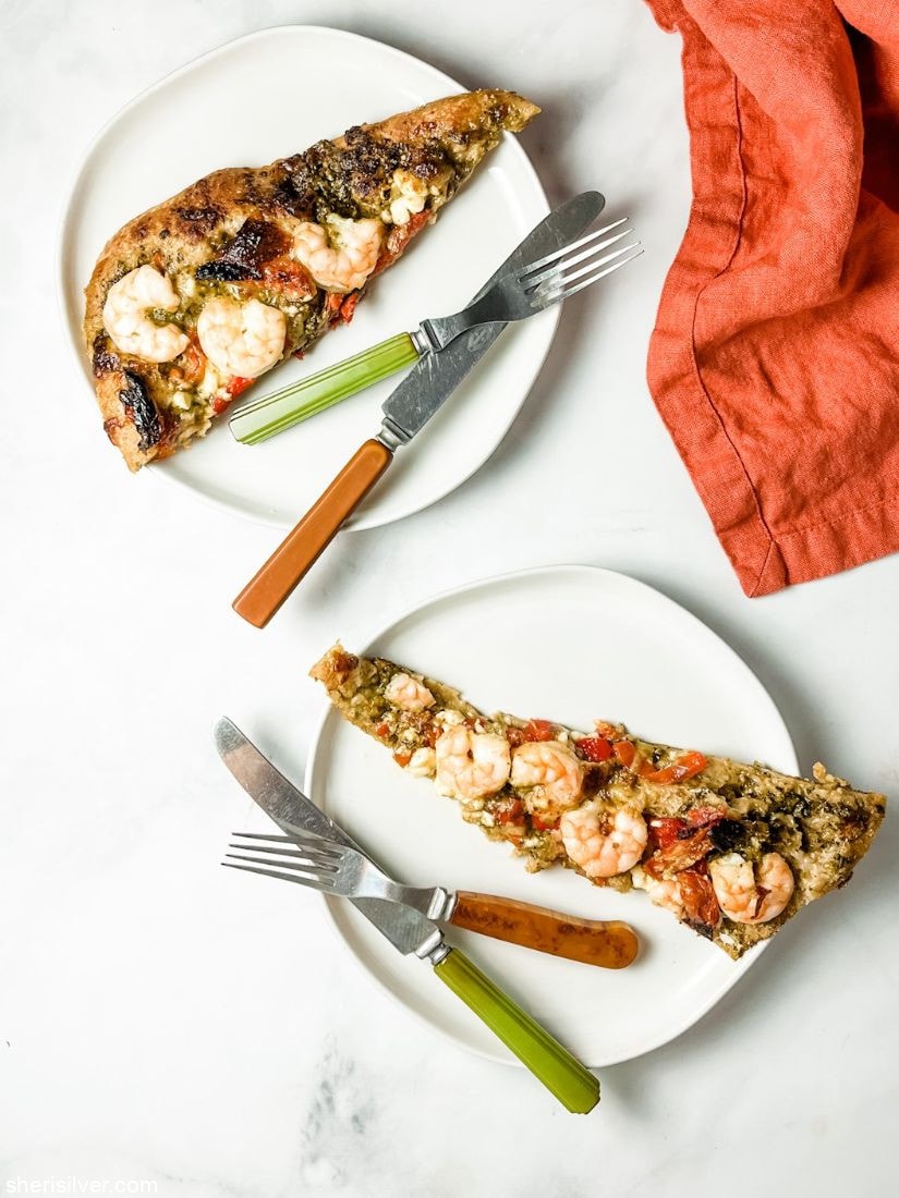 shrimp pesto pizza on white plates
