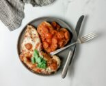 chicken polenta skillet on a gray ceramic plate with vintage cutlery