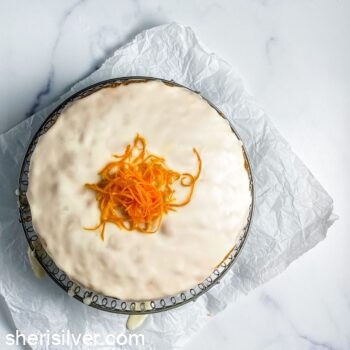 easy yellow cake topped with orange zest on a wire cooling rack
