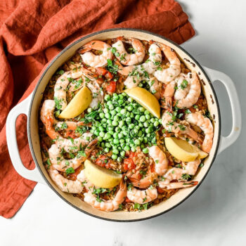 shrimp and rice with peas in a round skillet