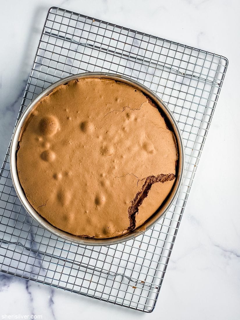 flourless chocolate cake on a wire cooling rack