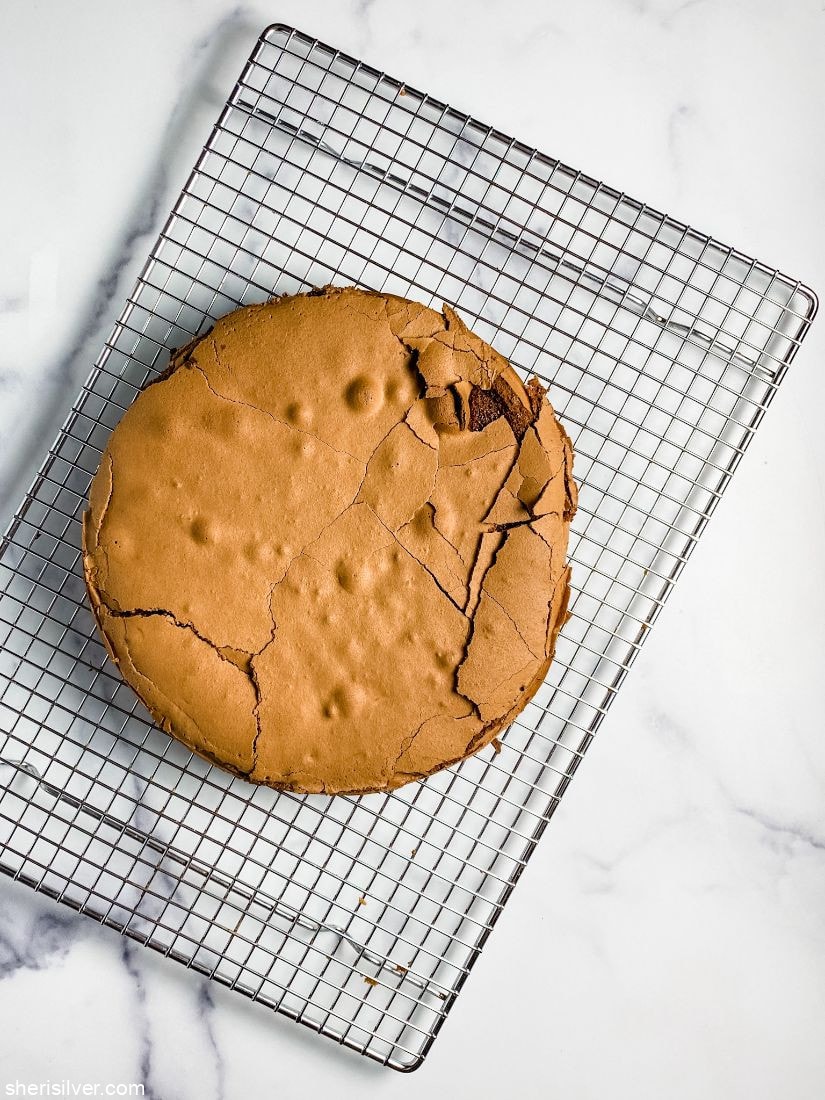 flourless chocolate cake on a wire cooling rack