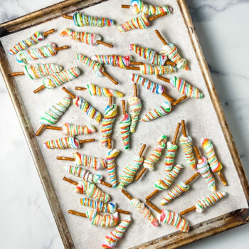 rainbow meringue pretzels on a baking sheet