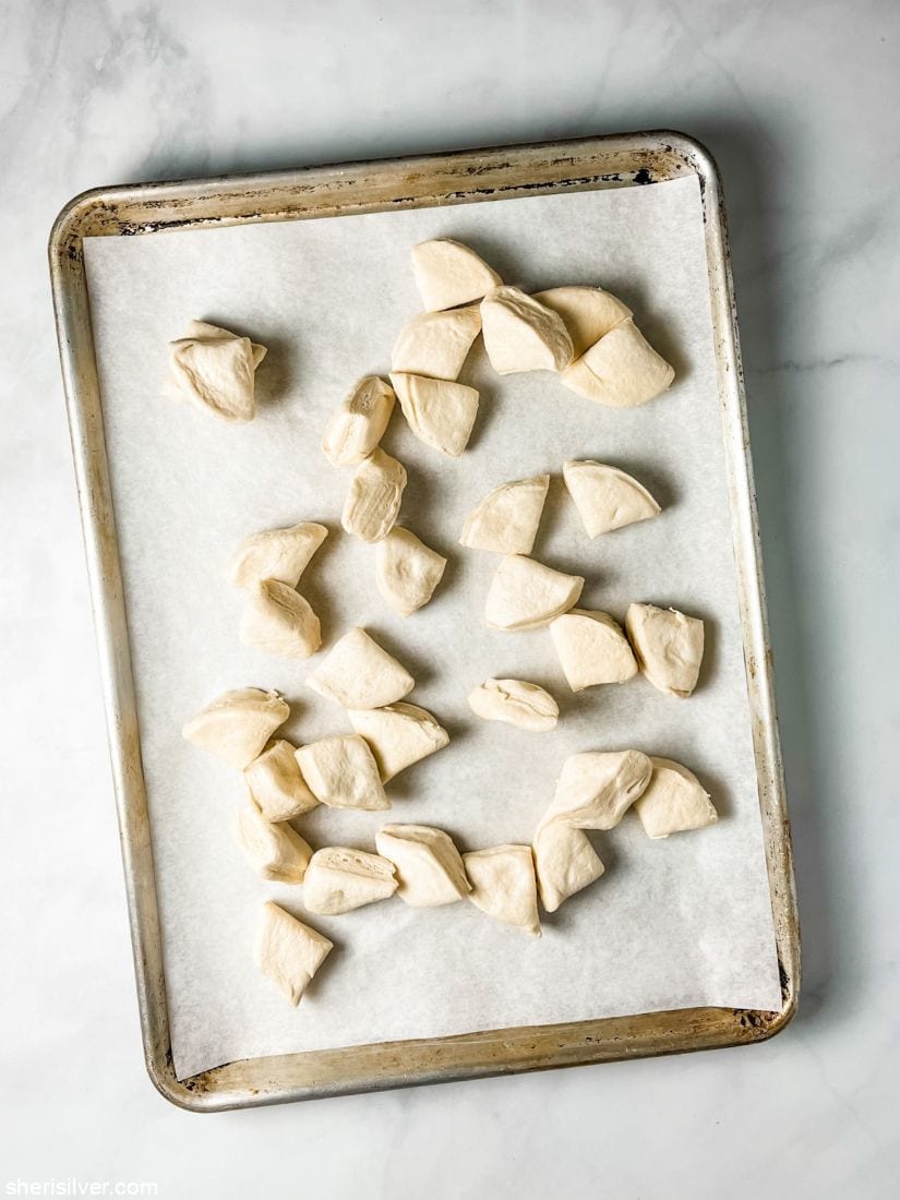 canned biscuit dough cut into quarters