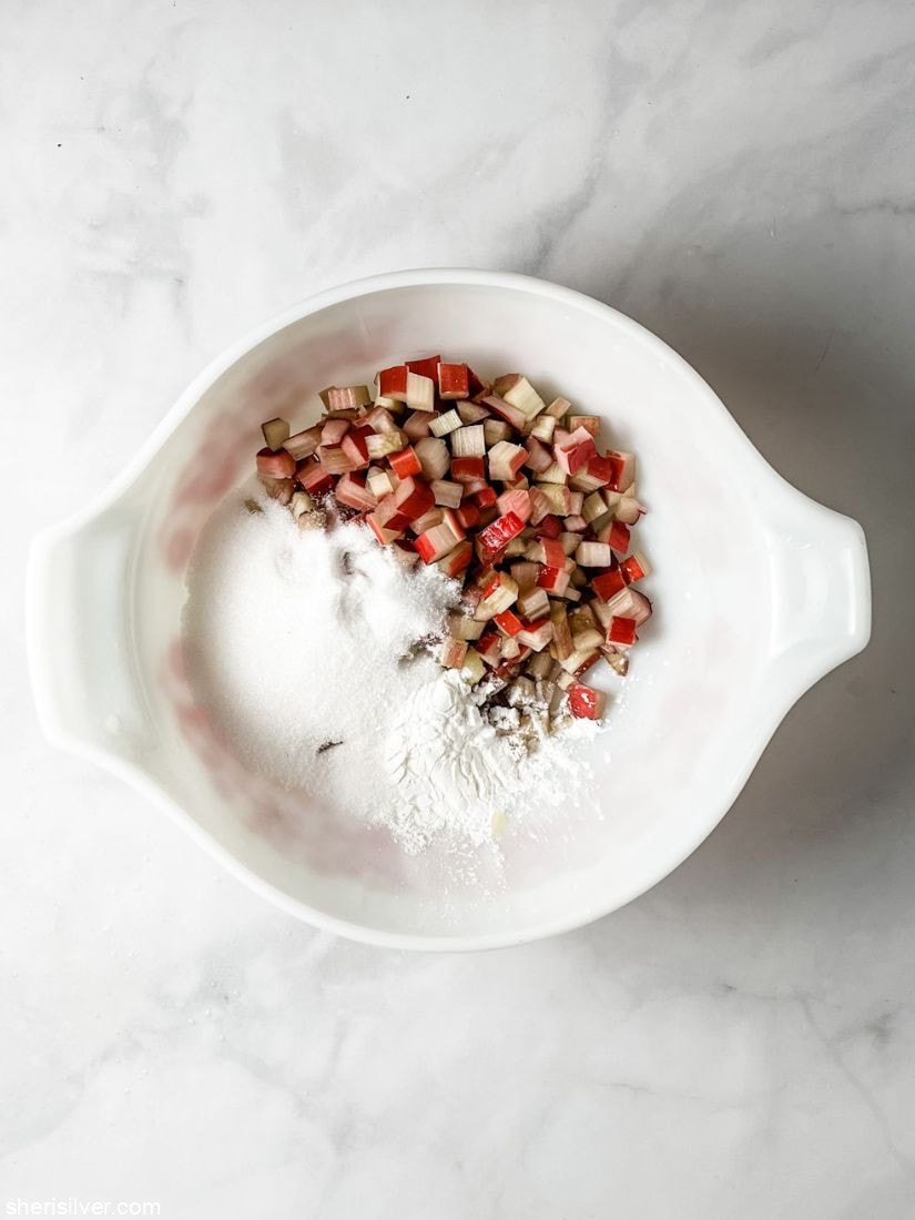diced rhubarb with sugar in a pyrex bowl