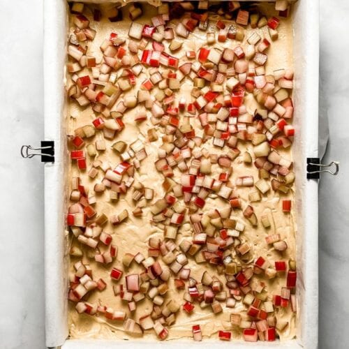 diced rhubarb on a layer of cookie dough