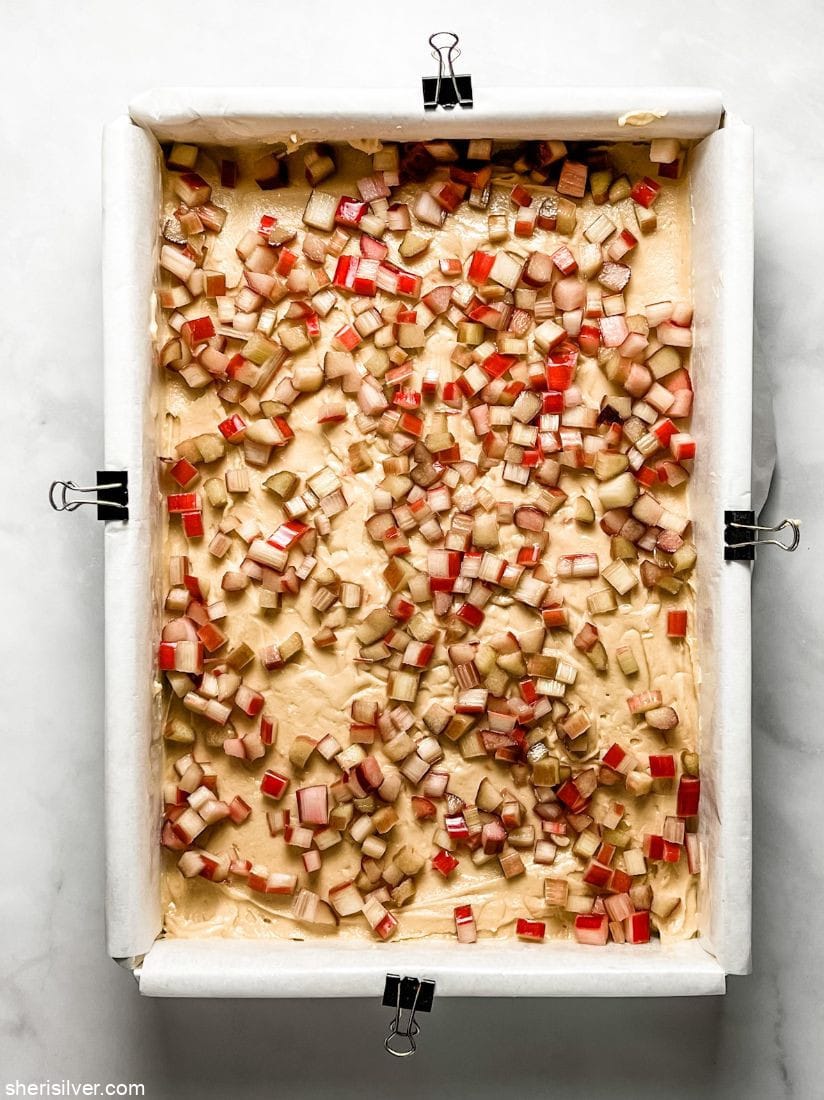 diced rhubarb on a layer of cookie dough