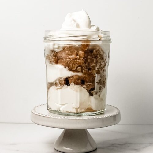 coffee granita with whipped cream in a jelly jar on a mini cake stand