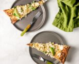 esquites pizza on gray ceramic plates next to a green linen napkin
