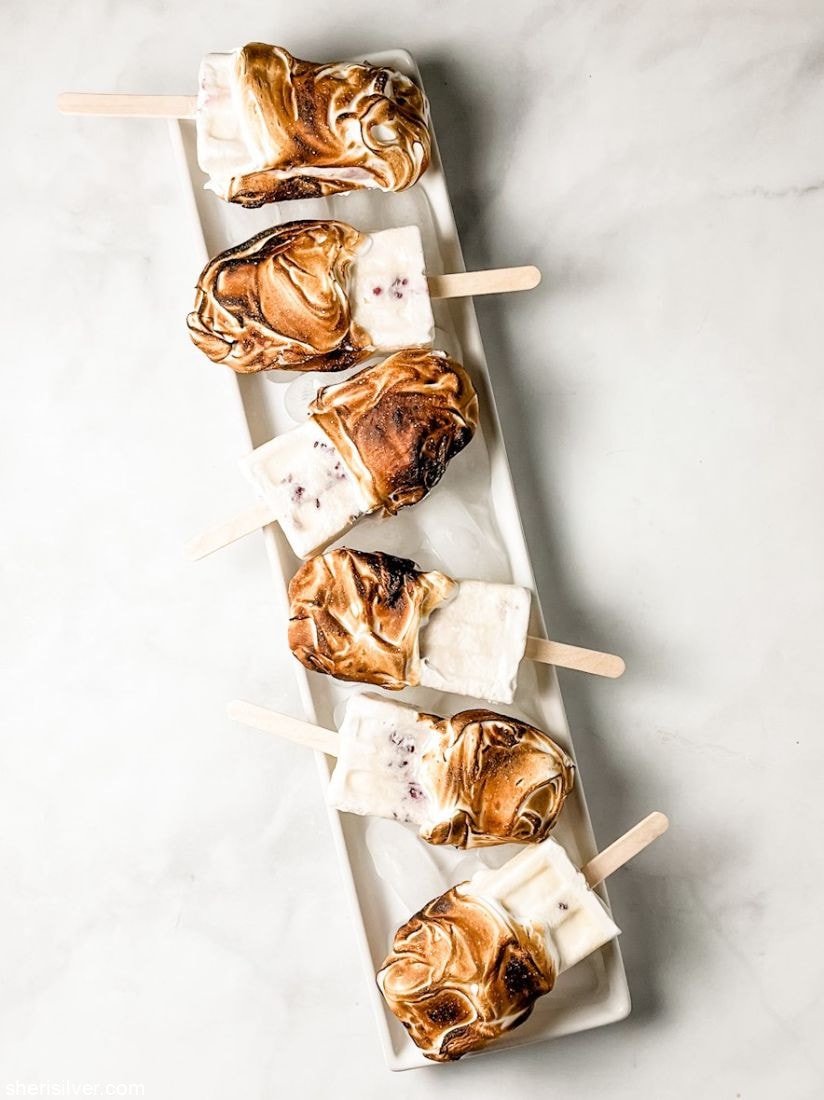 eton mess popsicles on a white ceramic tray