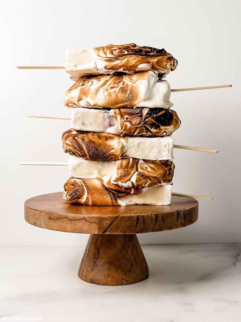 eton mess popsicles on a wooden cake stand