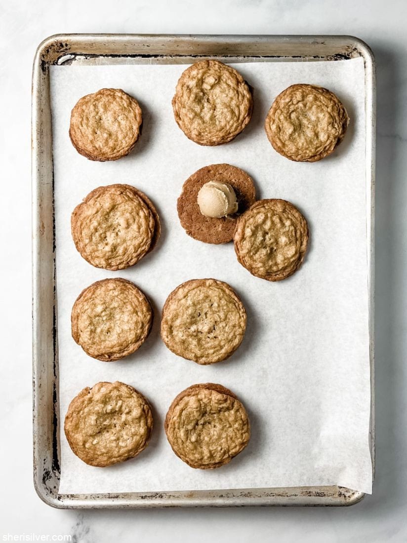 tahini oat sandwich cookies on a parchment lined baking sheet