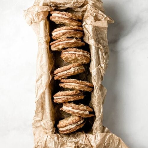 tahini oat sandwich cookies in a parchment lined loaf pan
