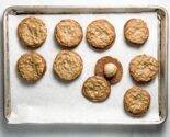 tahini oat sandwich cookies on a parchment lined baking sheet