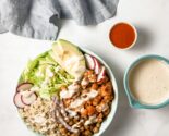 buffalo cauliflower bowls in ceramic dishes with bowls of dressing