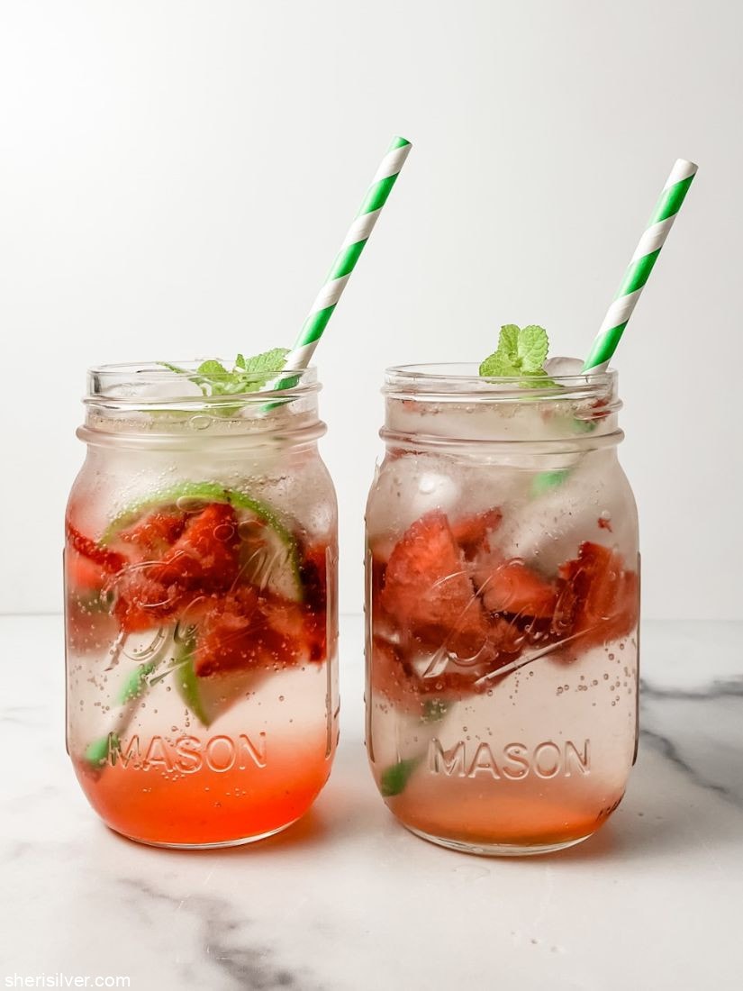 strawberry mock mojitos in mason jars with green striped straws