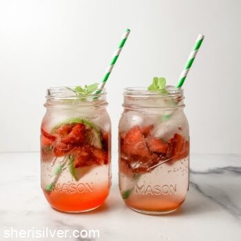 strawberry mock mojitos in mason jars with green striped straws