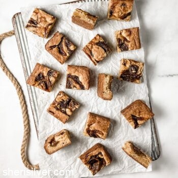 ginger pumpkin butter blondies on a parchment lined ribbed metal tray