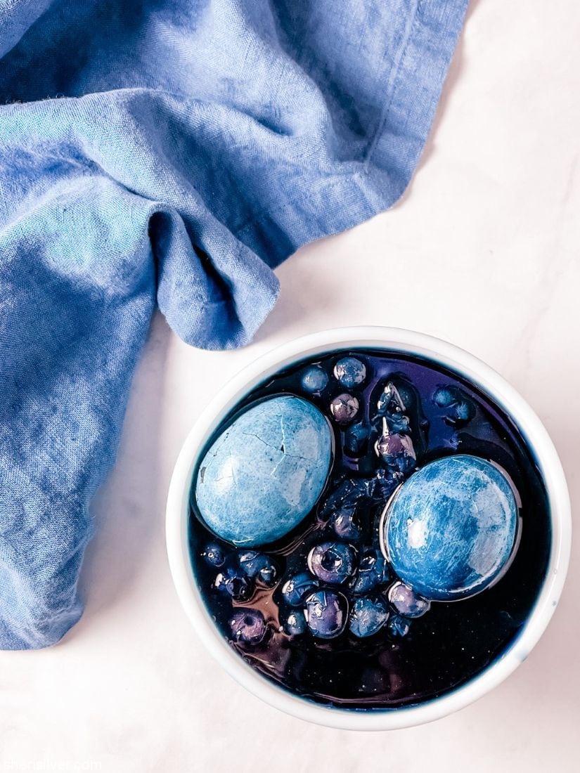 eggs and blueberries in a pyrex bowl with blue linen napkin