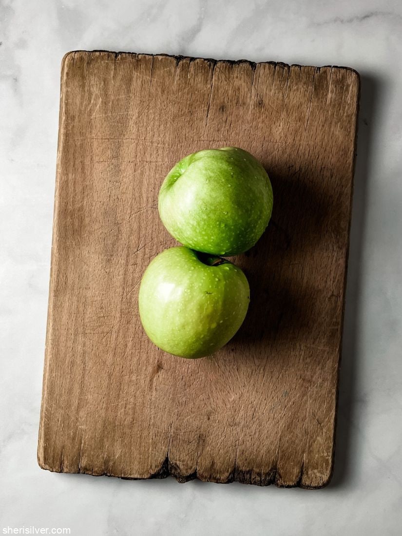 granny smith apples on a wooden board