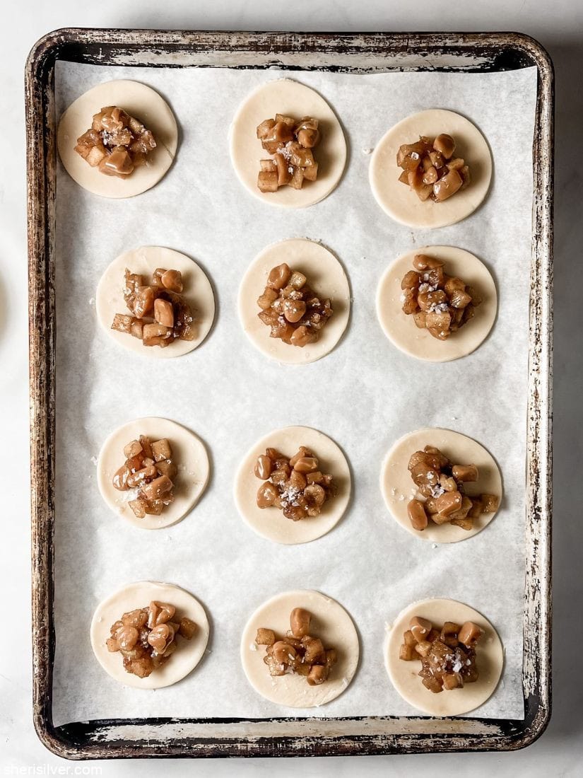 pie dough circles topped with apples and caramels