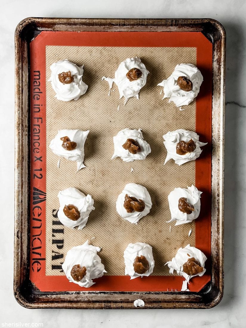 pumpkin butter meringues on a silpat lined baking sheet
