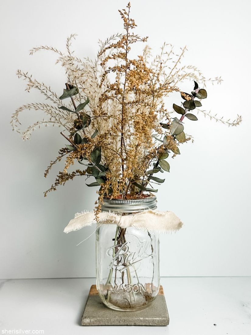 dried flowers arranged in a glass mason jar