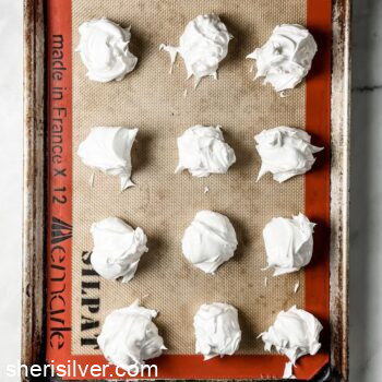 meringues on a silpat lined baking sheet