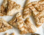 alfajores hamantaschen in an enamel tray with a metal cup filled with toasted coconut