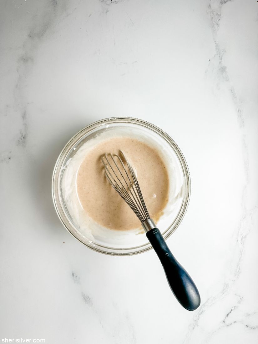 brown sugar glaze in a glass bowl with whisk
