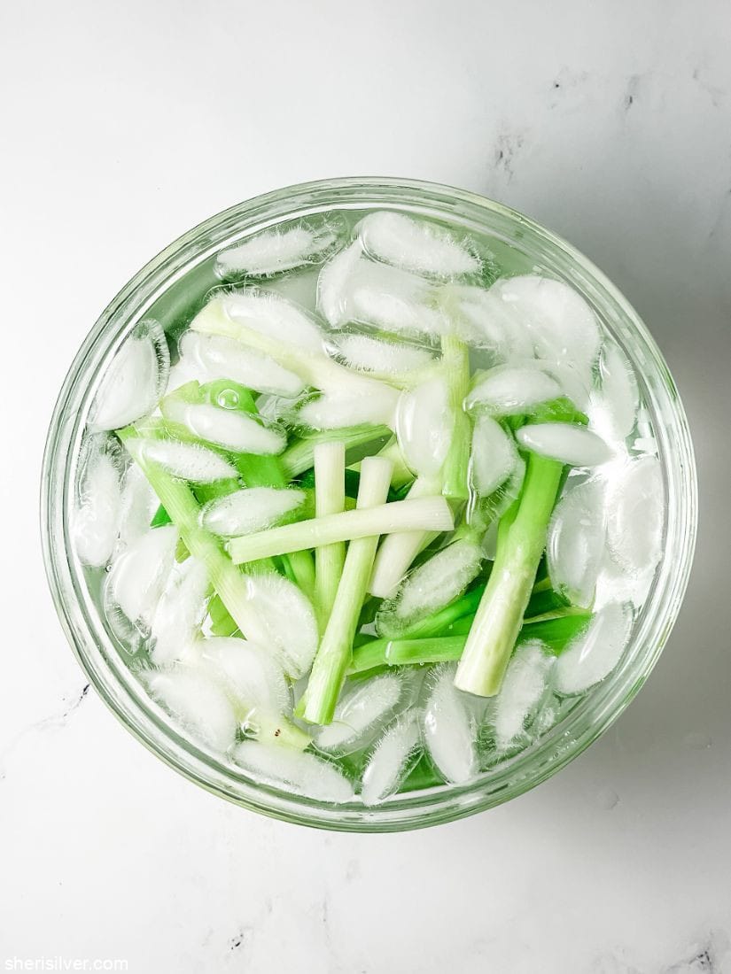 scallions in an ice water bath
