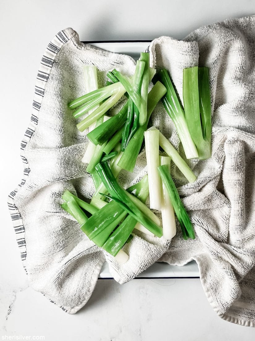 blanched scallions on a kitchen towel