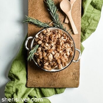 crispy white beans in a mini skillet on a wooden board with green linen napkin