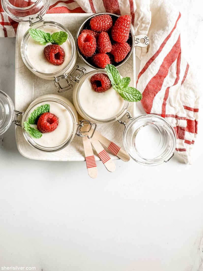 vanilla bean pudding in glass ramekins in a ceramic tray