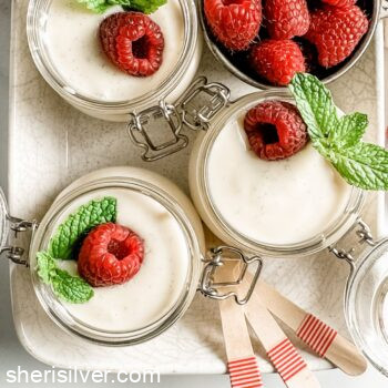 vanilla bean pudding in glass ramekins in a ceramic tray