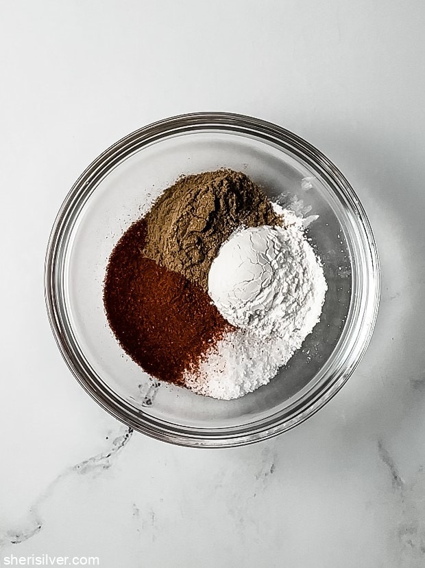 paprika in a small glass dish with cumin salt and baking powder