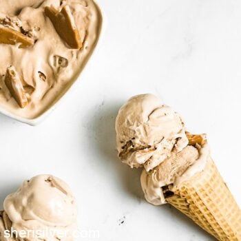 coffee malt ice cream scoops on sugar cones next to a ceramic dish of ice cream
