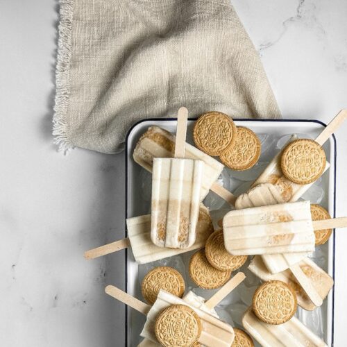 golden oreo milkshake pops in an enamel tray with golden oreos