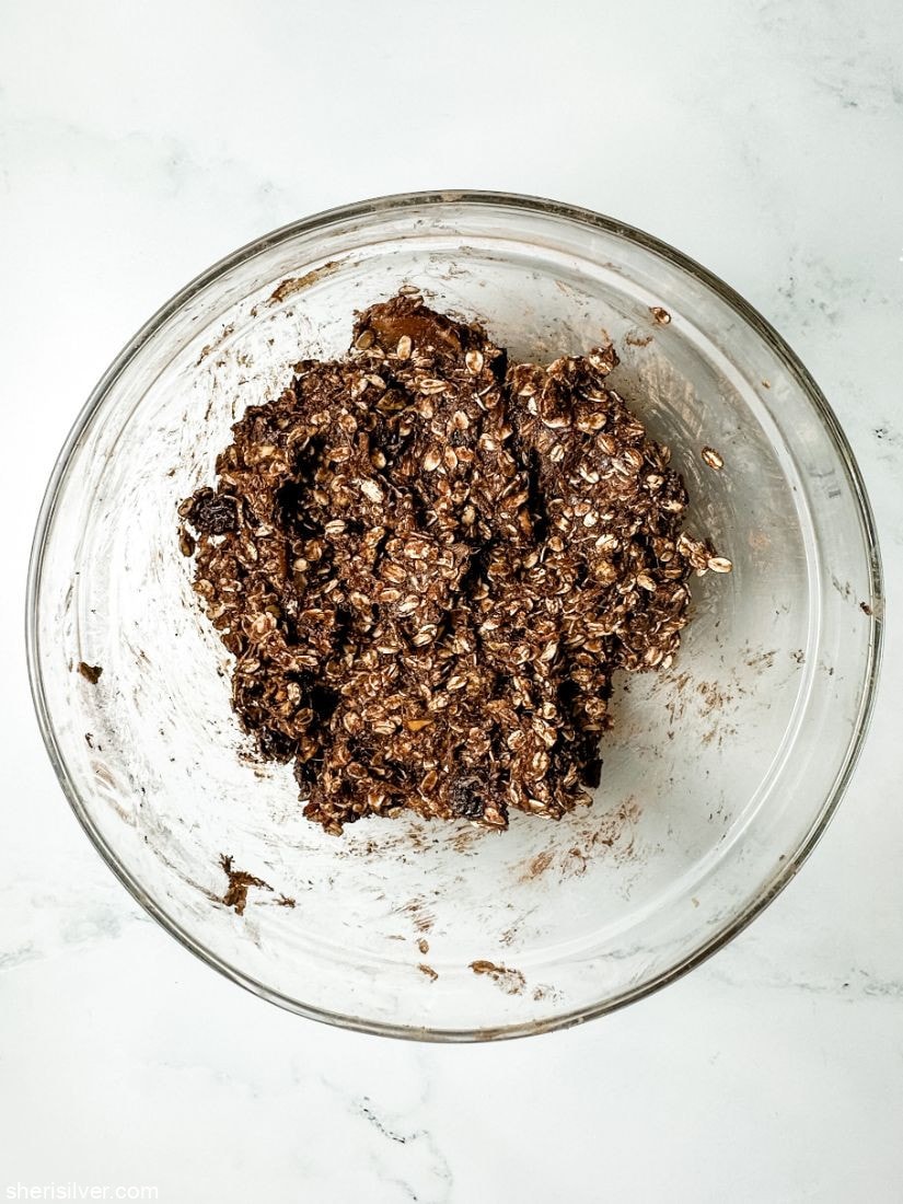 chocolate granola bar batter in a glass mixing bowl