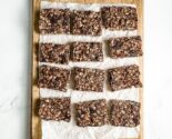 chocolate granola bars on a parchment lined wooden board
